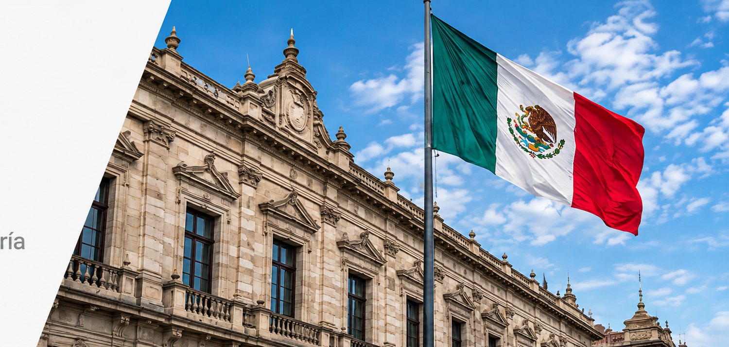 The stone facade of a public building with the Mexican flag flying in the foreground.